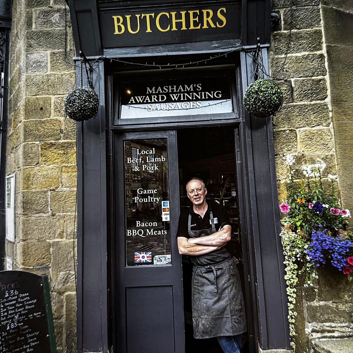 Richard Welford in the doorway of Beavers Butchers on Silver Street, Masham, under the gold BUTCHERS fascia